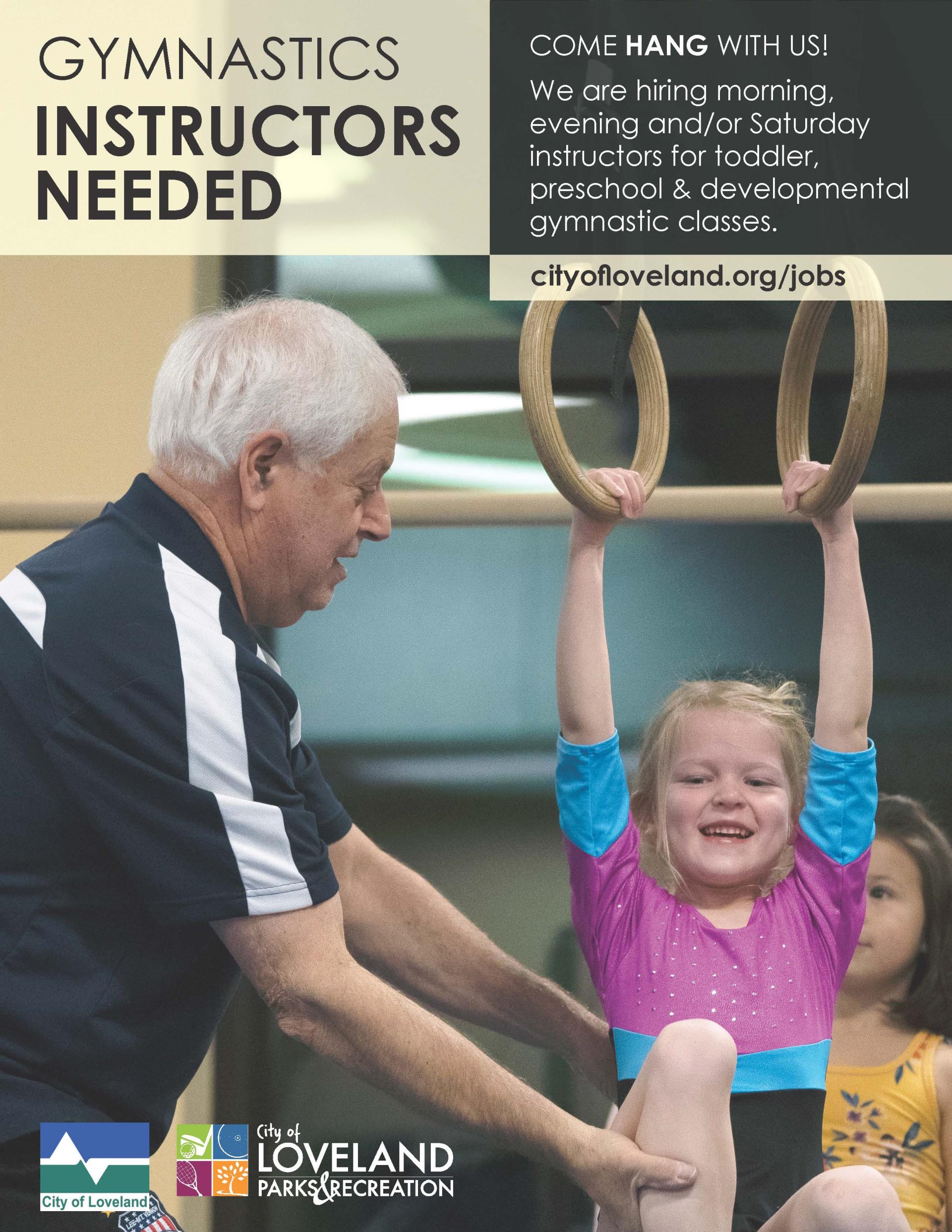 male gymnastics instructor spotting girl on rings