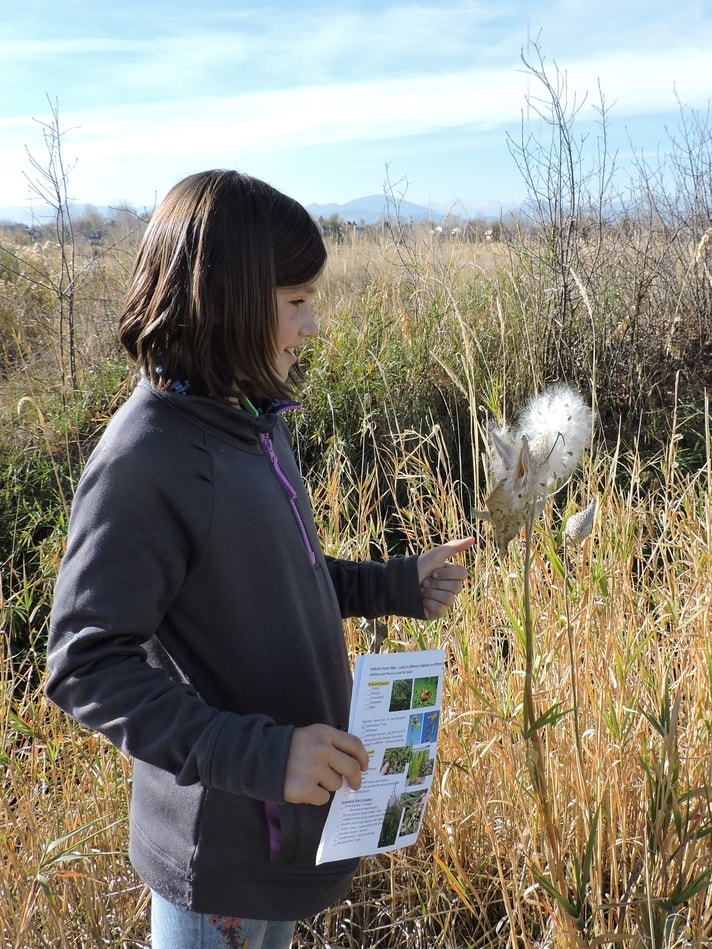 student looking at plants in Loveland