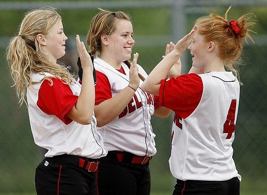 3 softball players high five