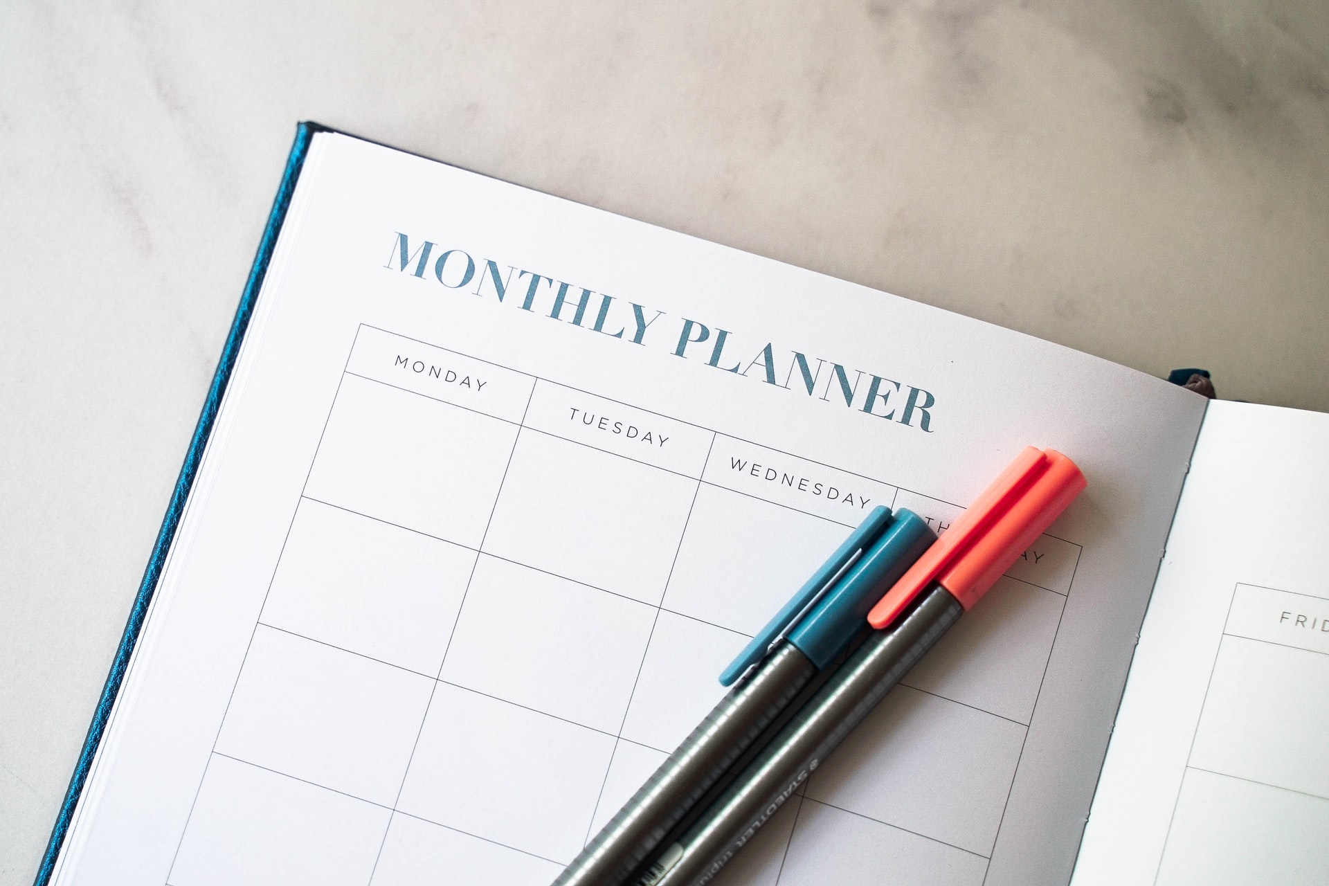 Monthly planner with pens