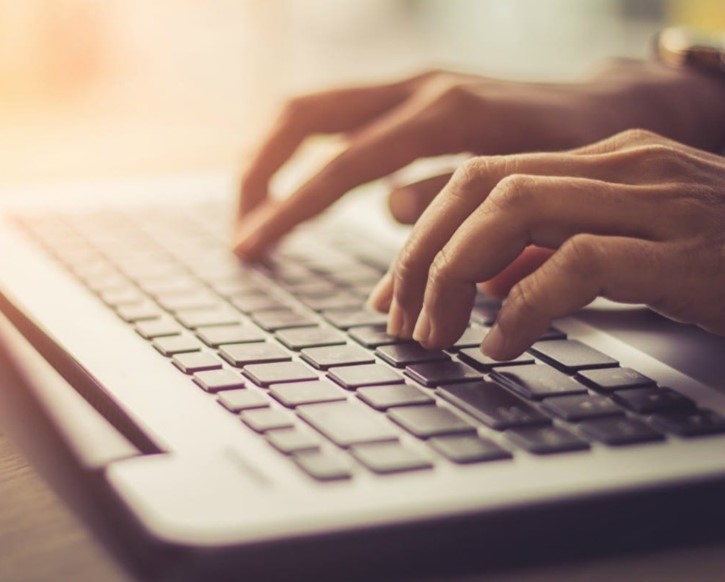 A person typing on the computer