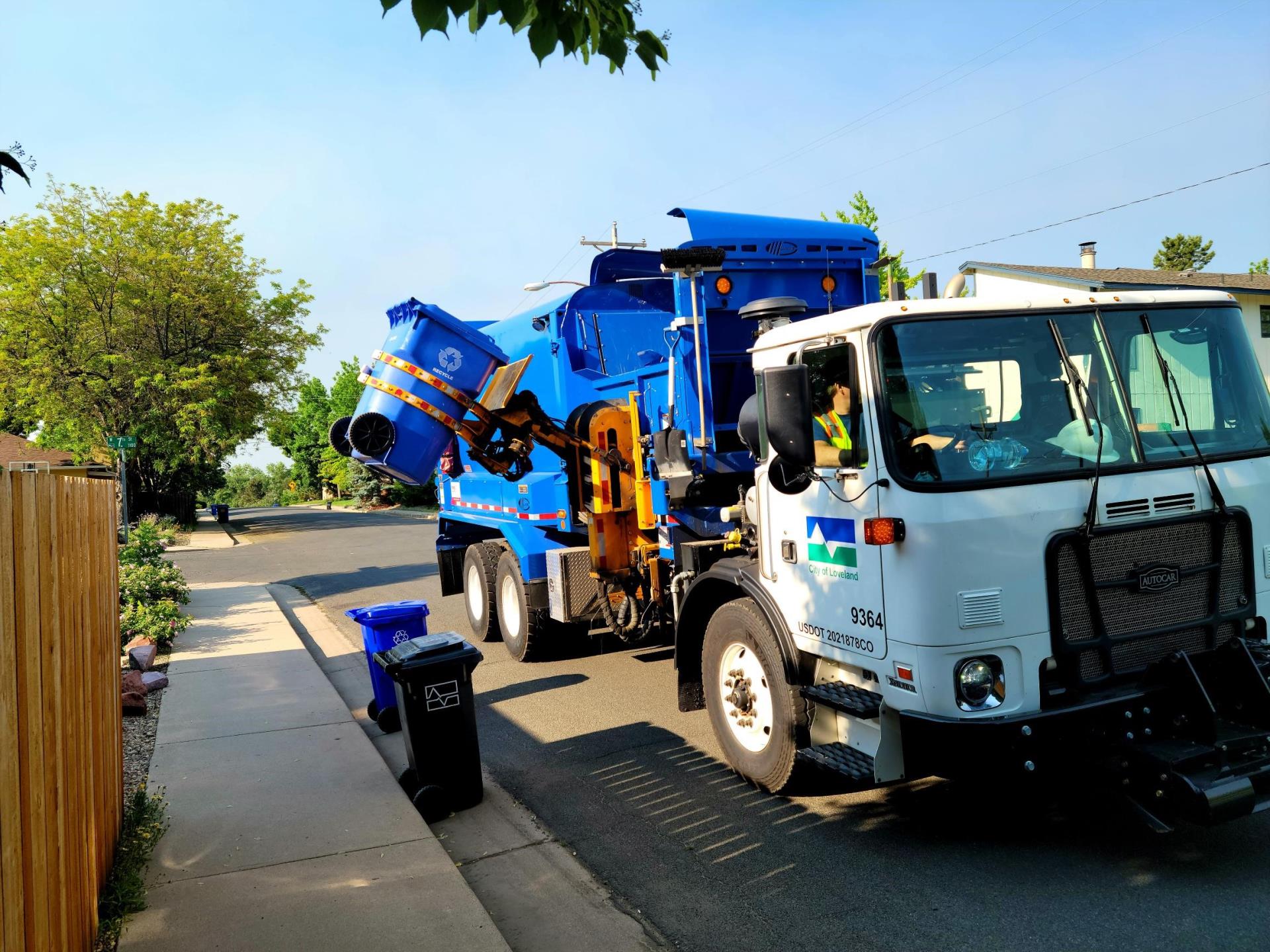 A City of Loveland Recyling Truck picks up a recycling bin.