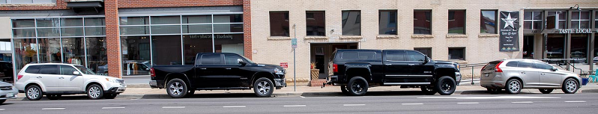 Several cars parked along a street.