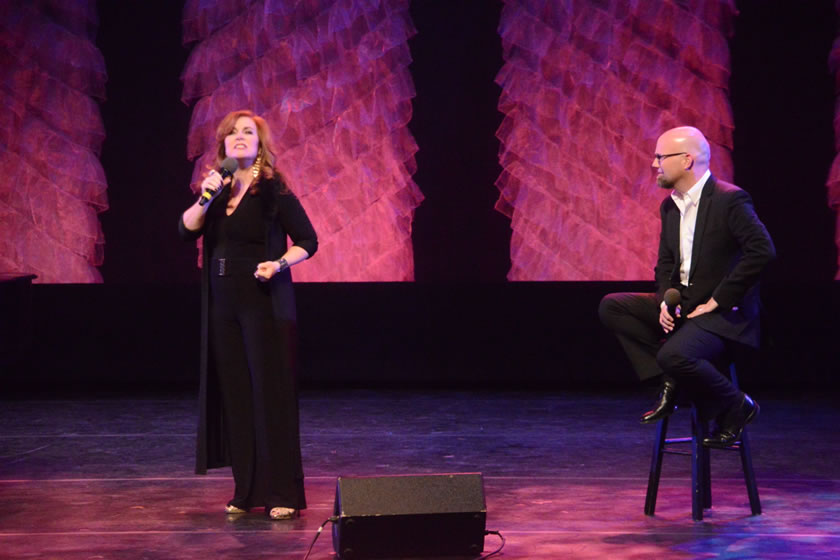 two people standing on stage