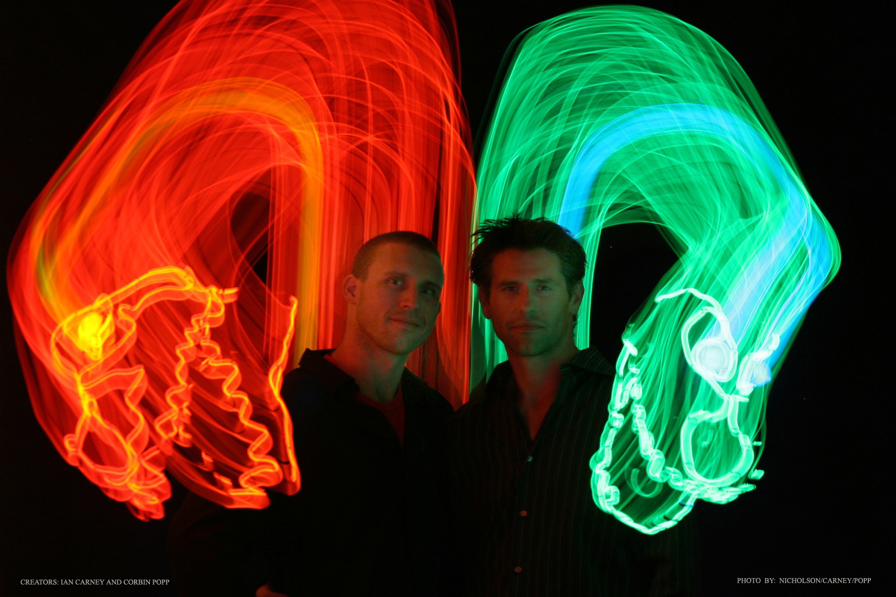 two men with laser lights in green and red