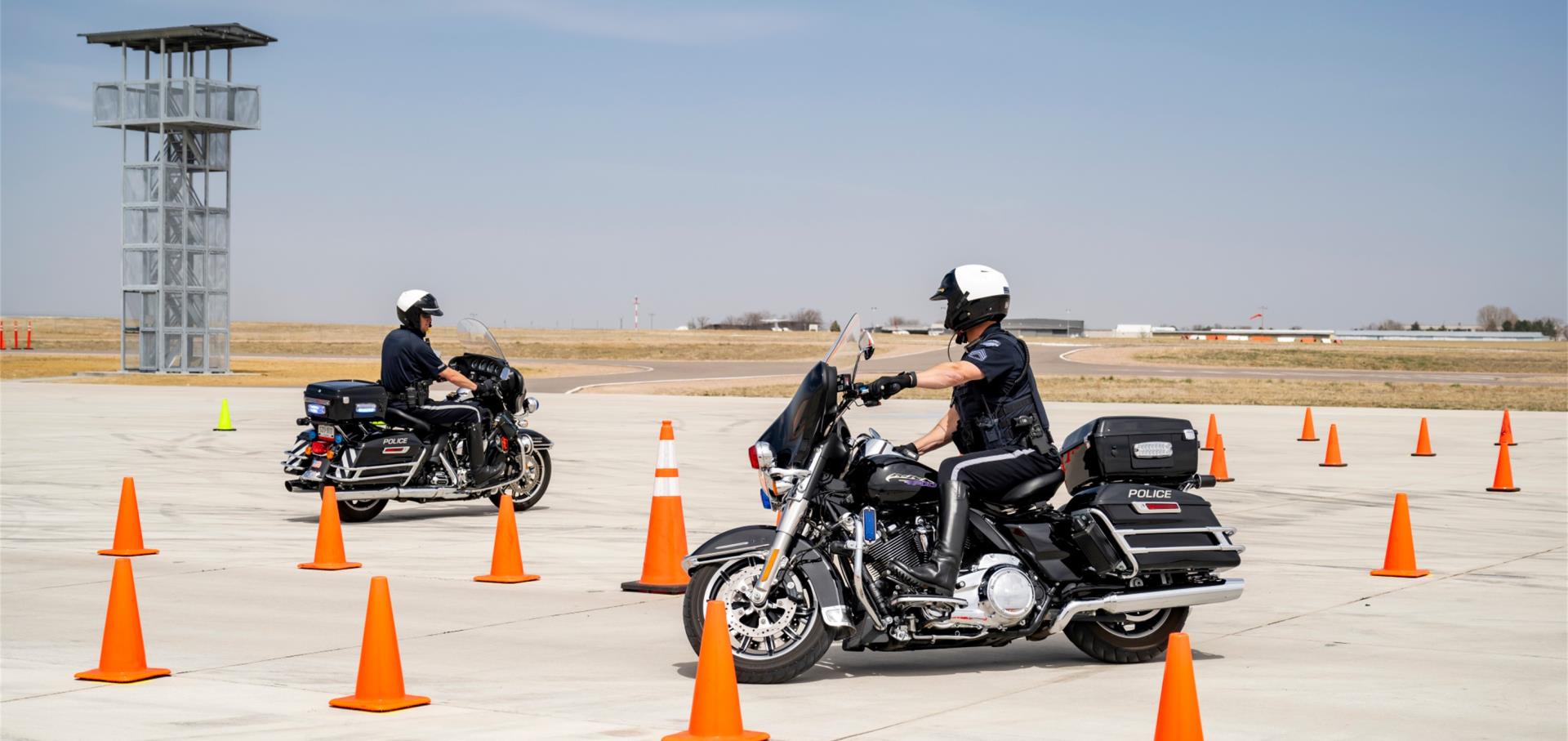 police motorcycles driving through cones during training