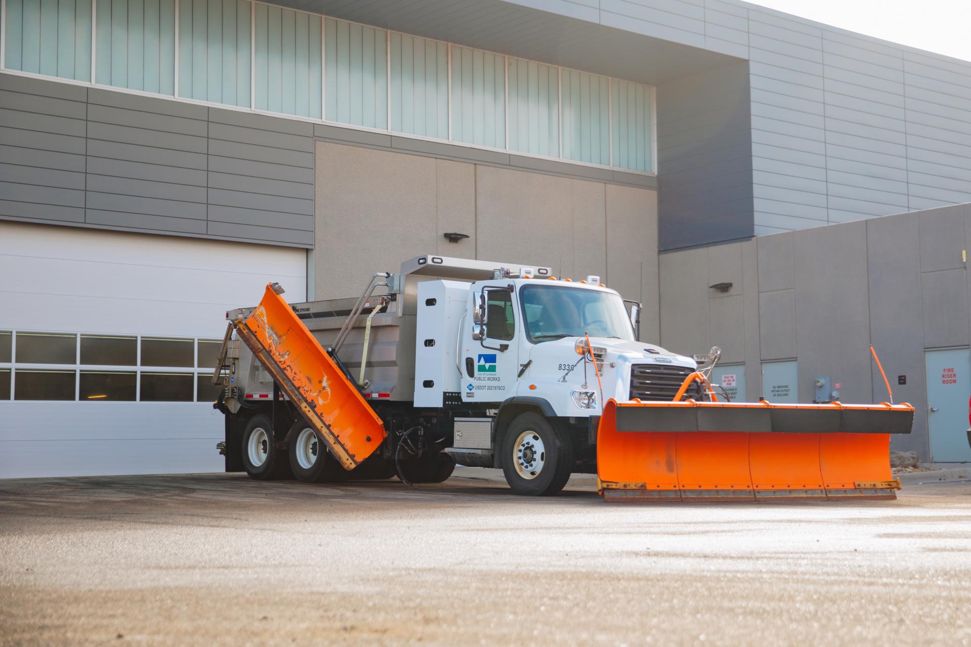 A parked snow plow waiting to jump into action.