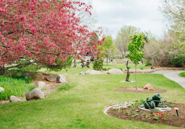 Benson Sculpture Garden with several sculptures and a large tree in the background.