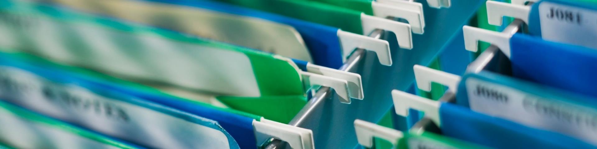 Several file folders hanging in a filing cabinet.