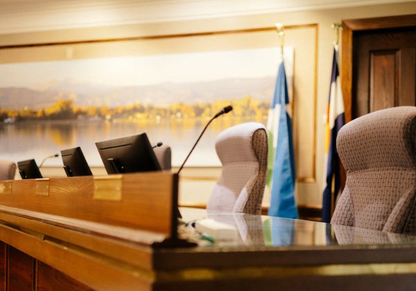 Empty chairs in council chambers.